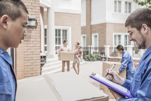 Professional movers packing household items in London