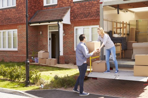 Professional movers handling household items in London
