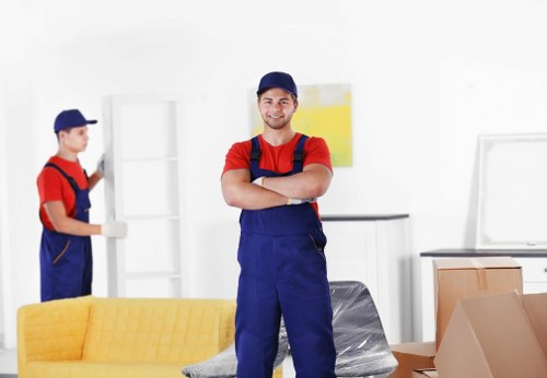 Professional movers handling office equipment
