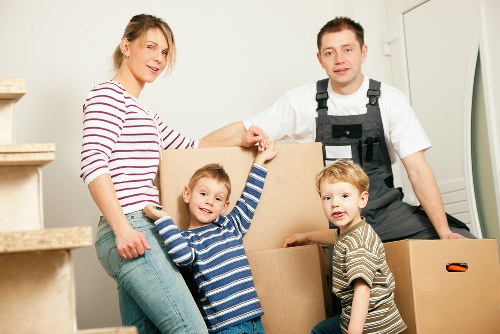 Two movers carrying boxes down a stairwell