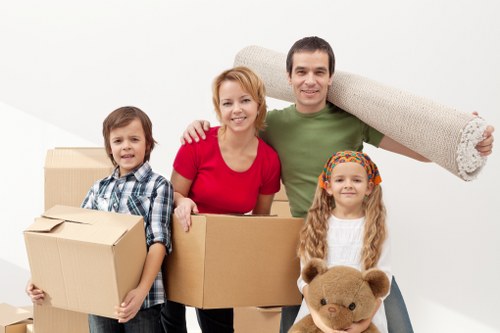 Professional movers securing items in truck
